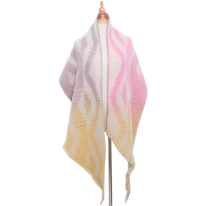 Detailed view of thick knit poncho scarf featuring purple and yellow geometric diamond patterns