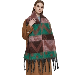 Winter heart jacquard scarf with geometric patterns and black tassels on a wool coat