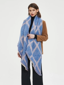 Détail d'une écharpe à carreaux bleu marine et rose avec maille épaisse et longues franges