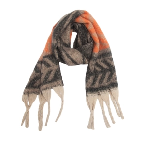 Close-up of geometric leaf pattern and fringe tassels on thick mohair-style scarf