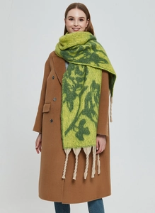 Close-up of green rose jacquard mohair scarf with thick beige fringes and soft texture