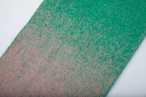 Detail of soft mohair texture and green to pink gradient color on knitted scarf