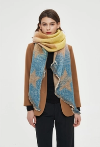 Detailed close-up of thick star pattern knit scarf with fringe edges and color blocking
