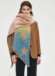 Detailed texture of thick striped shawl with large star patterns and fringed edges