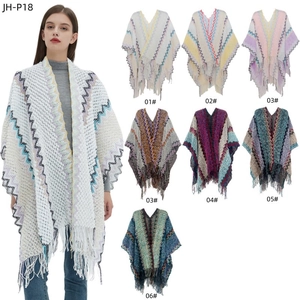 Women's knit poncho with zigzag patterns and long tassels in a bohemian style