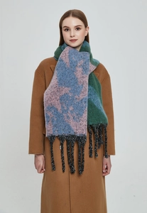 Detail of color-block knit scarf with abstract patterns and long fringe tassels