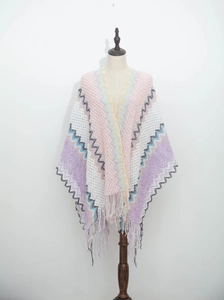 Detailed view of bohemian chevron knit shawl with colorful wave patterns and tassel fringe