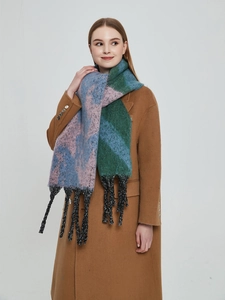 Close-up of thick boucle scarf with fringe and color-block star pattern in winter