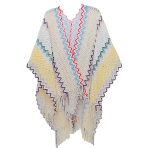 Detail of bohemian knit shawl with colorful zigzag patterns and fringe trim edges