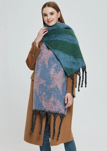 Detail of color-block knit scarf with star patterns and long fringe tassels on the edges