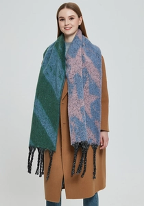 Close-up of thick knit scarf with colorful star patterns and long black tassels