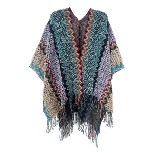 Close-up of bohemian knit shawl detailing colorful zigzag patterns and long fringe tassels