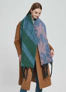 Detailed view of color-block knit scarf featuring star patterns and thick tassels