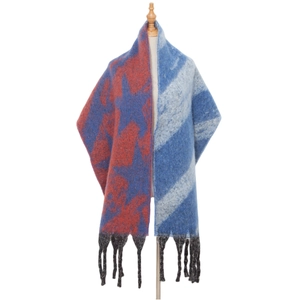 Close-up of thick knit scarf with star pattern patchwork and long black tassels