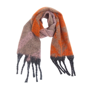 Detail of chunky star pattern scarf with orange tassels and thick knitted texture