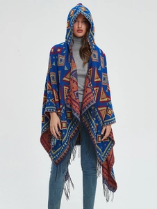 Detail of hooded poncho with royal blue tribal geometric patterns and black fringe