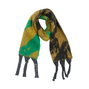 Macro detail of tricolor knit scarf with abstract geometric pattern and chunky tassels