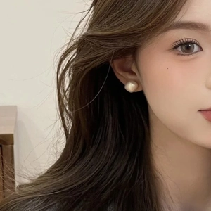 Elegant cream square pearl stud earring on model showing perfect size and soft luster