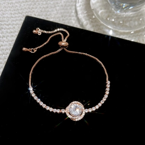 Elegant rose gold adjustable bracelet with a large circular zircon and pavé detailing
