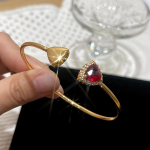 Elegant 18K gold plated open bangle featuring a triangle red zircon and pavé crystals