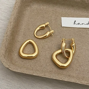 Polished gold geometric earrings set with hollow circular and triangular designs