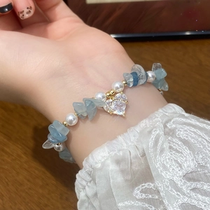 Handmade bracelet with blue crystals, pearls and a gold-plated zircon heart charm