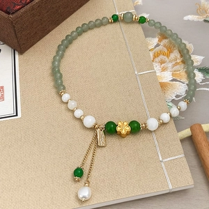 Handmade beaded bracelet with green chalcedony and freshwater pearls with gold flower charm
