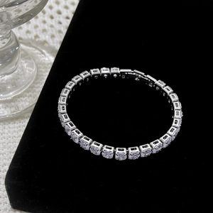 Elegant silver tennis bracelet with sparkling cubic zirconia on a black velvet display