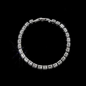 Detail of silver tennis bracelet with square-cut cubic zirconia and folding clasp
