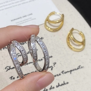Irregular geometric hoop earrings featuring double-layered design and cubic zirconia inlay