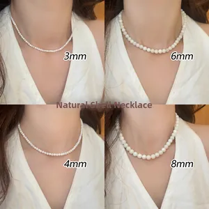 Detail of natural seashell beaded necklaces showing 3mm to 8mm sizes on a model