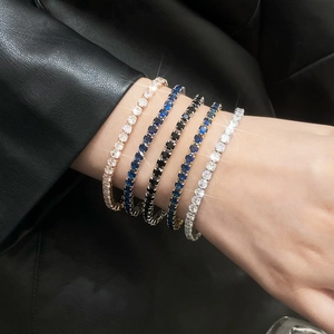 Elegant stacked tennis bracelets in gold, silver, and rose gold with vibrant colorful zircon stones