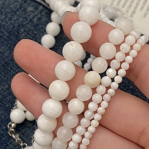 Elegant French INS style shell bead necklaces in various sizes on denim background