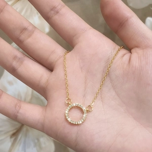 Minimalist gold plated circular pendant necklace with shimmering micro-pave cubic zirconia