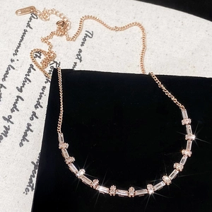 Rose gold baguette cut zircon necklace on black velvet with a vintage aesthetic