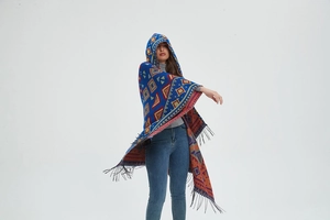 Close-up of bohemian hooded poncho featuring geometric patterns and fringe hem details