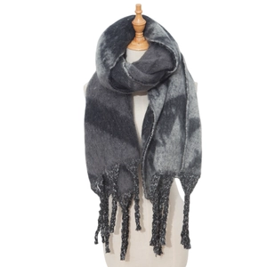 Close-up of thick tassel details on a gray star pattern knit scarf for winter warmth