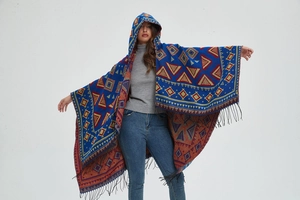 Close-up of bohemian hooded poncho featuring geometric patterns and fringe hem