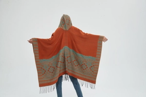 Détail d'un poncho à capuche bohème avec jacquard floral ethnique et longues franges