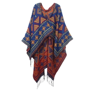 Close-up of geometric jacquard knit pattern and black tassels on hooded poncho shawl