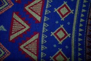 Close-up of geometric ethnic pattern on hooded poncho with textured woven fabric