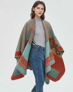 Detailed knit texture and vibrant geometric jacquard patterns on orange split shawl