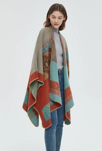 Detailed view of bohemian jacquard knit patterns and stitching on orange cashmere shawl