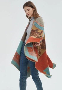 Detail of bohemian orange knit shawl showing intricate geometric patterns and fine stitching