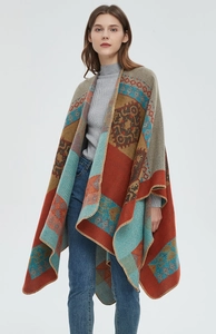 Detail of bohemian jacquard knit poncho with tribal geometric patterns and stitched edges