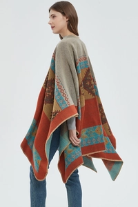 Detail of bohemian geometric knit shawl showing thick texture and precise stitched edges