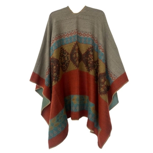 Detailed knit texture of orange bohemian poncho with geometric patterns and fringe