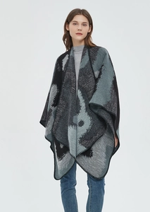 Close-up of edge stitching on a knit leopard pattern shawl cape with jacquard texture