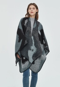 Detailed view of large leopard print jacquard poncho with black blanket-stitch edges