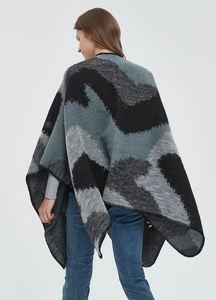 Detail of double-sided jacquard shawl featuring large leopard pattern and split hem